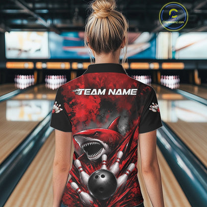 Person wearing a bowling shirt with a shark design and 'Team Name' text in a bowling alley.