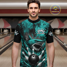 Load image into Gallery viewer, Man wearing a teal and black bowling shirt with a shark design in a bowling alley.