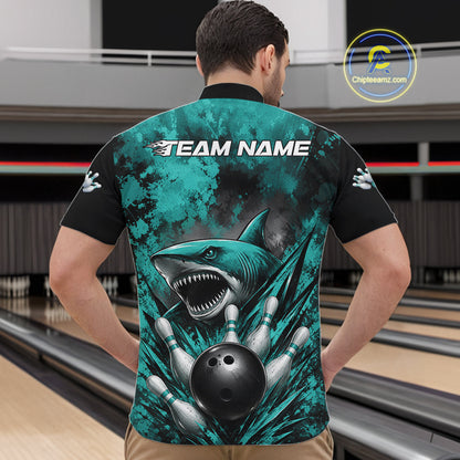 Person wearing a teal and black bowling shirt with a shark design at a bowling alley.