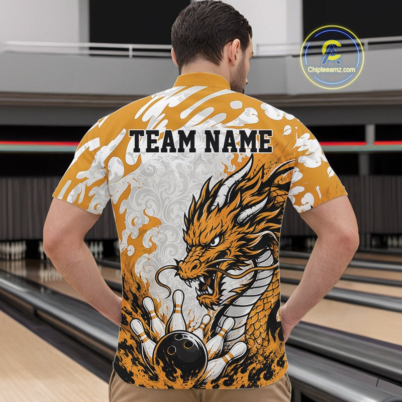 Man wearing a bowling shirt with a dragon design and 'TEAM NAME' text in a bowling alley.
