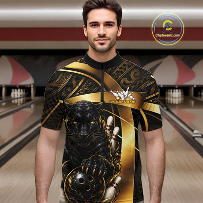 A man wearing a custom bowling-themed short-sleeve shirt with a black and gold design featuring a panther and bowling pins, set against a blurred bowling alley background.