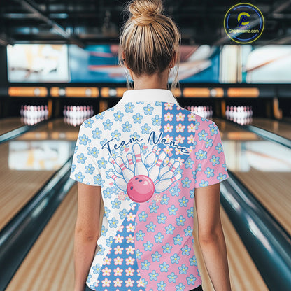 Back view of a female model in a bowling lane wearing a white quarter-zip shirt featuring white, blue and pink floral pattern with refined decorative styling.