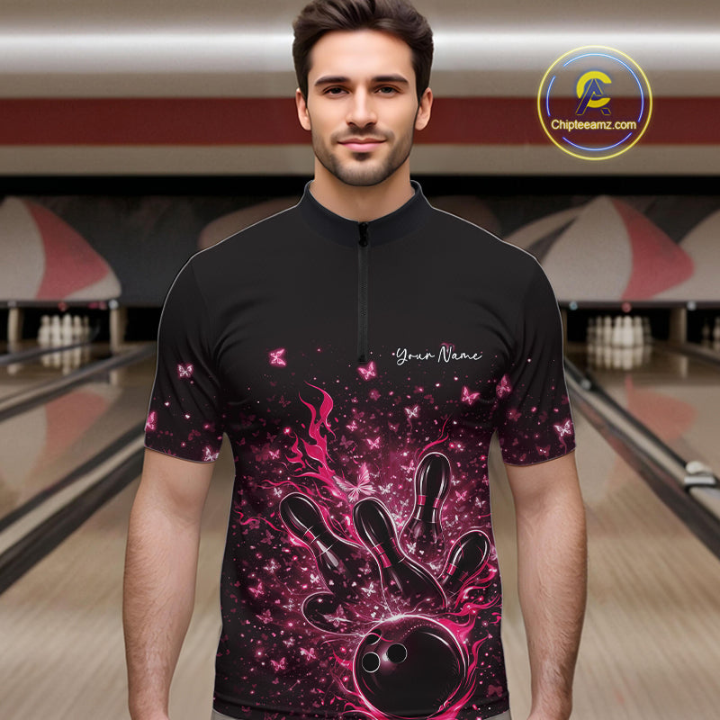 Male model wearing a black and pink bowling quarter-zip shirt at the lane with flaming bowling ball artwork.