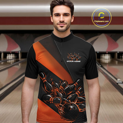 Male model in a bowling venue front view wearing a black and orange quarter zip shirt with a fiery bowling ball hitting pins in energetic bowling action artwork.
