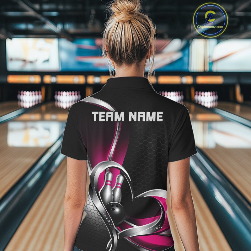 Back view of a female model in a bowling lane wearing a black and pink polo shirt, showcasing honeycomb pattern and heart-shaped bowling action illustration.