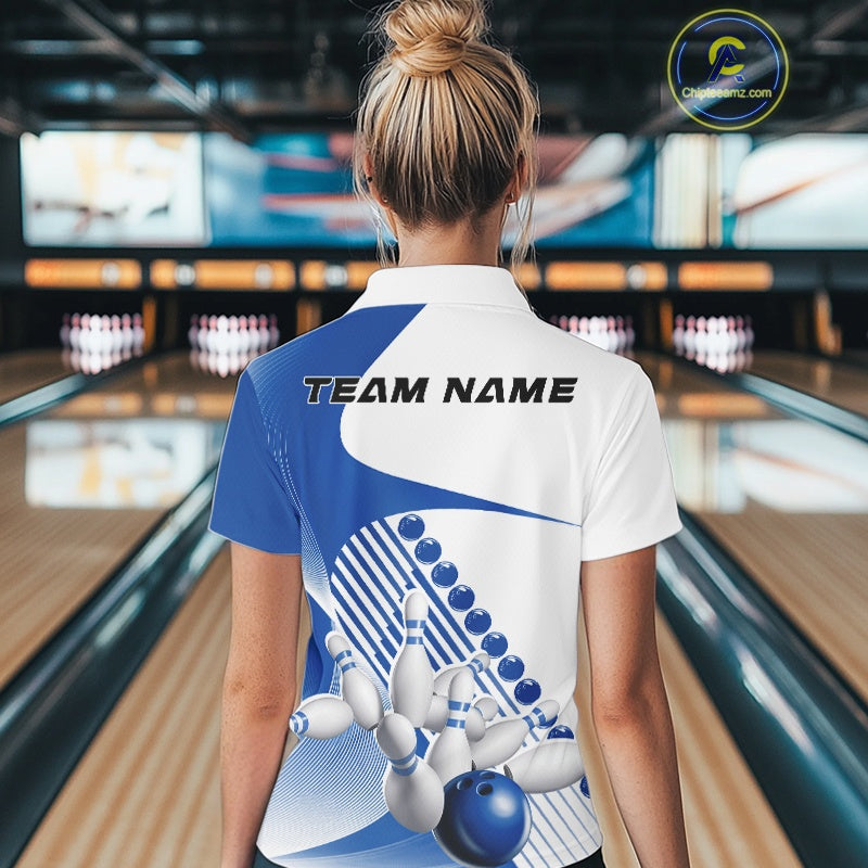 Back view of a white and blue women s bowling quarter zip with asymmetric wavy stripe accents and dynamic bowling-themed artwork in a bowling center.