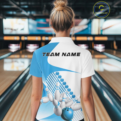 Back view of a white and light blue women s bowling quarter zip with asymmetric wavy stripe accents and dynamic bowling-themed artwork in a bowling venue.