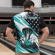 Load image into Gallery viewer, Back view of a man in a bowling alley wearing a black, white, and blue american flag cobra-themed shirt with “Team Name” across the shoulders.