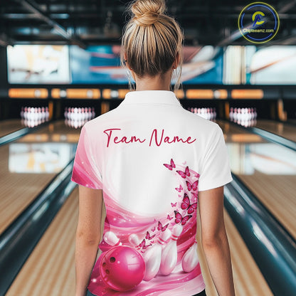 Back view of a women s white and pink bowling quarter zip displaying butterfly artwork and bowling-themed graphics inside a bowling alley.