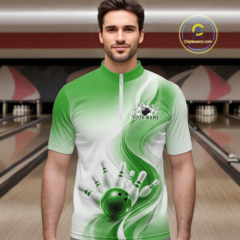 Male model in a white and green bowling quarter zip shirt with abstract flowing wave accents and glossy bowling strike graphics, front view at a bowling lane
