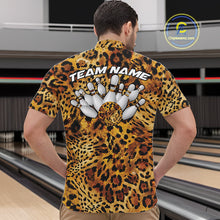 Load image into Gallery viewer, Leopard-print bowling team shirt shown on a men facing the lanes, with a back design of bowling pins, a spotted ball, and customizable team name lettering.

