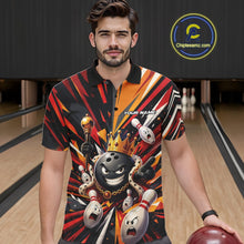 Load image into Gallery viewer, Front view of a male model wearing a black, red, and orange bowling polo shirt featuring a crowned cartoon bowling ball with a royal scepter leading animated bowling pins through radiant bursts of color at a bowling lane.