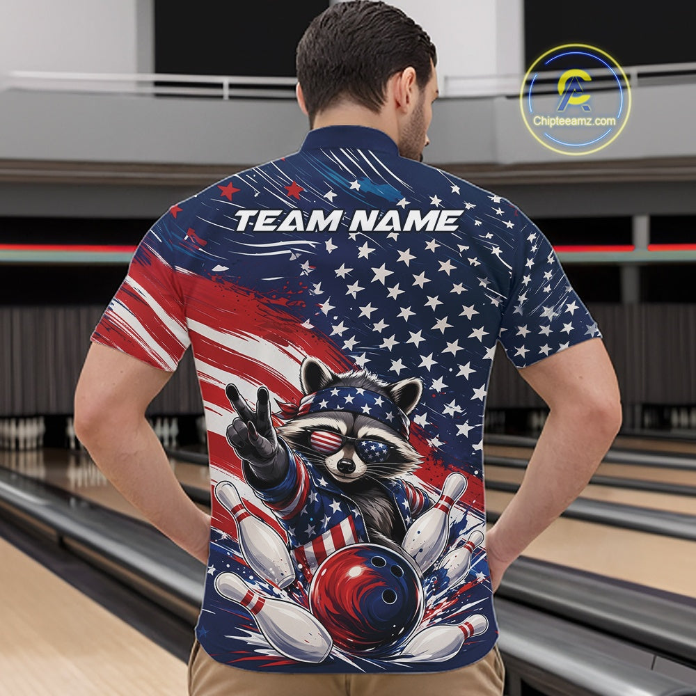 Front view of a male model wearing a bowling quarter zip shirt with artwork of a patriotic raccoon, a red, white, and blue bowling ball striking pins, and a flowing American flag at a bowling lane.