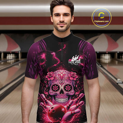Male model at a bowling lane wearing a black and pink bowling quarter-zip shirt with vibrant sugar skull artwork and bowling-themed details.