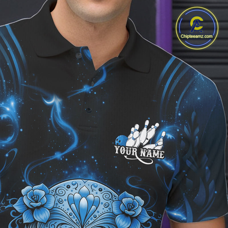 Close-up of a black and blue bowling polo shirt left chest featuring a floral sugar skull above a bowling ball and pins.