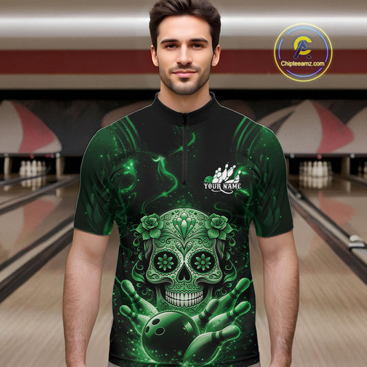 Male model wearing a black and green bowling quarter-zip shirt at a bowling lane with Day of the Dead sugar skull artwork and bowling-themed graphics.
