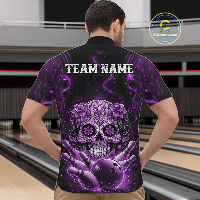 Front view of a male model in a bowling center wearing a black and purple bowling quarter-zip featuring Day of the Dead sugar skull graphics above bowling pins.