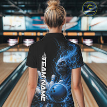 Load image into Gallery viewer, Back view of a female model in a bowling alley wearing a black bowling quarter zip shirt featuring a blue fiery skull with lightning striking a bowling ball and pins and a custom name.
