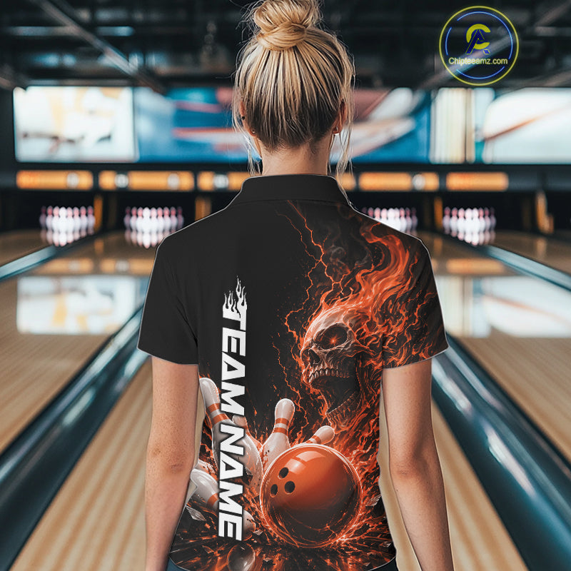 Back view of a female model in a bowling alley wearing a black bowling quarter zip shirt featuring an orange fiery skull with lightning striking a bowling ball and pins and a custom name.
