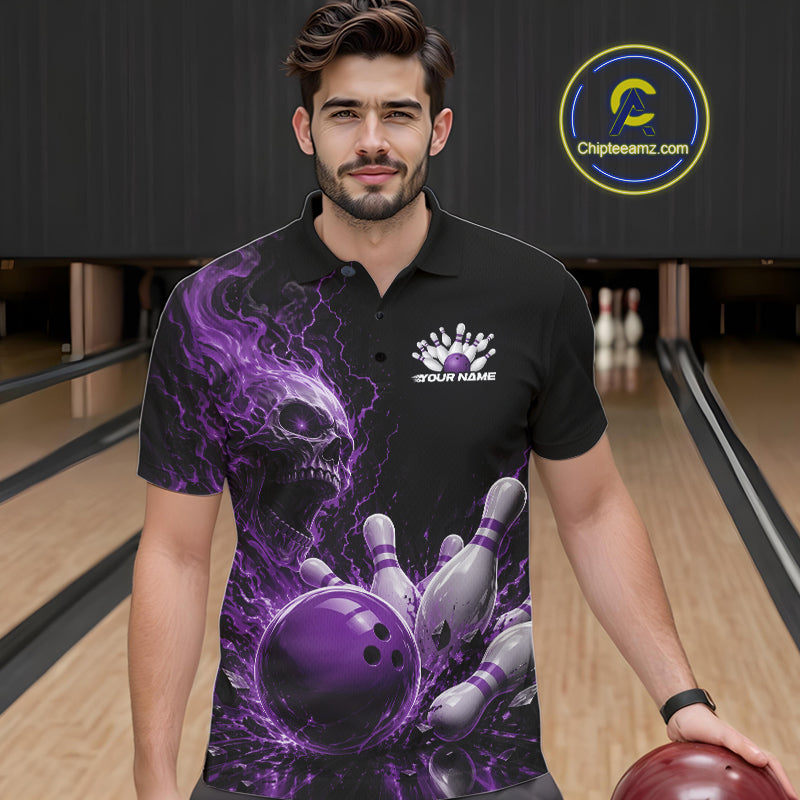 Front view of a male model in a bowling alley wearing a black bowling polo shirt featuring a purple fiery skull design with lightning striking a bowling ball and pins and a custom name.

