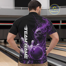 Load image into Gallery viewer, Front view of a male model in a bowling alley wearing a black bowling quarter zip shirt featuring a purple fiery skull design with lightning striking a bowling ball and pins and a custom name.
