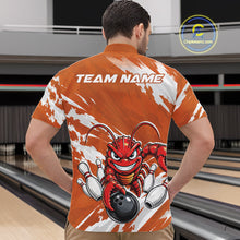 Load image into Gallery viewer, Back view of a male model in a bowling alley wearing an orange custom quarter zip bowling shirt with an aggressive crawfish bowling design and a distressed background.