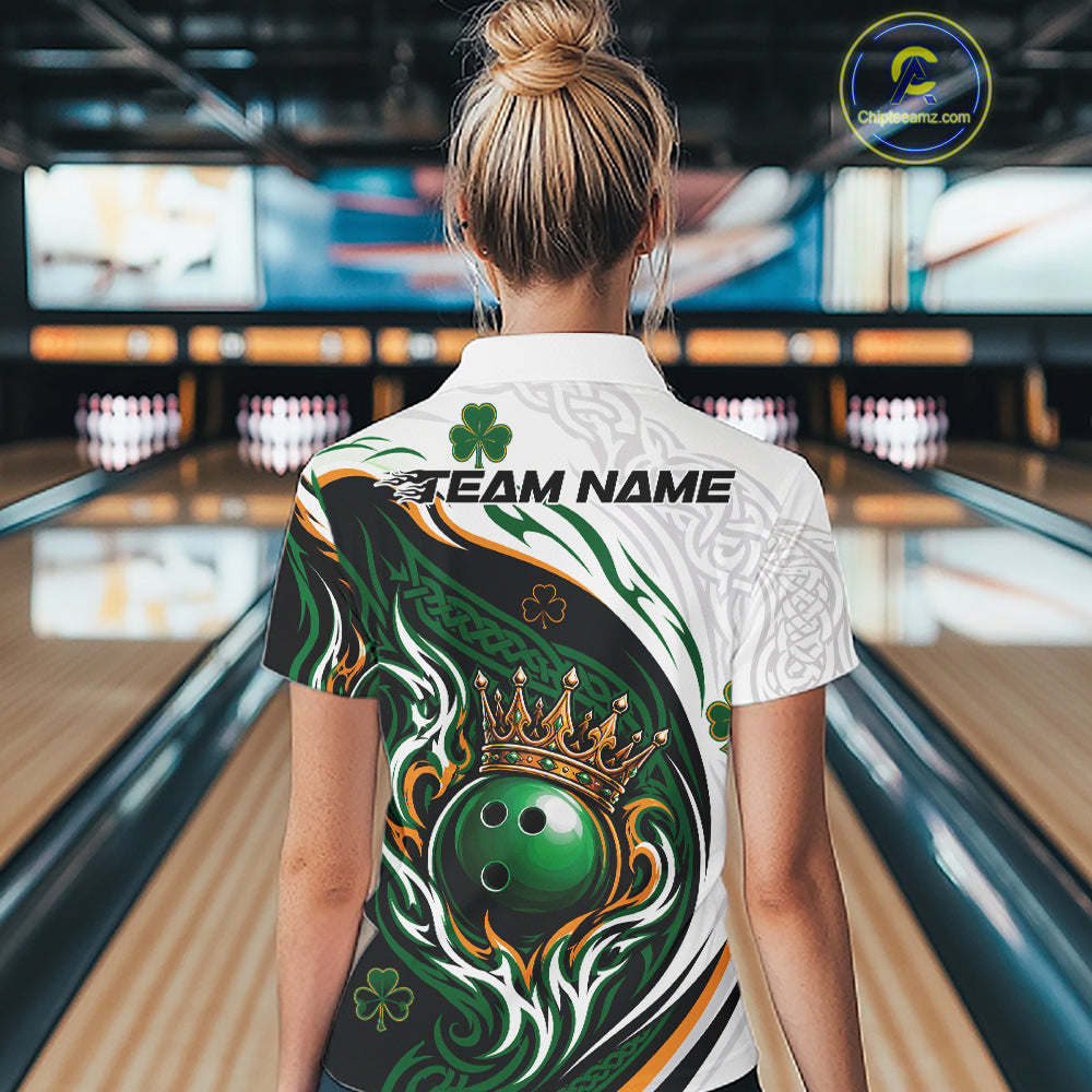 A woman viewed from behind wearing a St. Patrick's Day themed bowling polo shirt in a bowling alley.