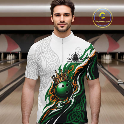 A man wearing a custom short-sleeve bowling quarter zip shirt with a white base, green and orange flame patterns, a crown and bowling ball graphic