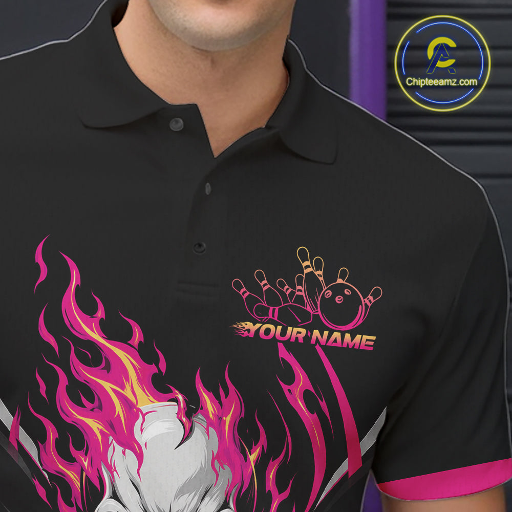 A close-up of a black polo shirt worn by a model, featuring a custom bowling-themed graphic with pink and yellow flames, bowling pins, a bowling ball