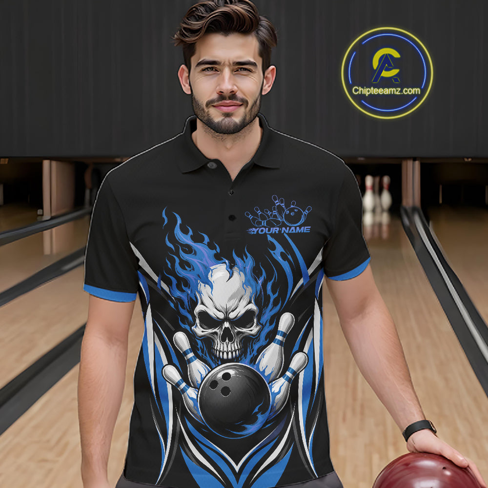 A man wearing a black short-sleeve polo shirt with a blue and white skull bowling graphic, standing in a bowling alley. The shirt features a large skull holding a bowling ball with blue flames