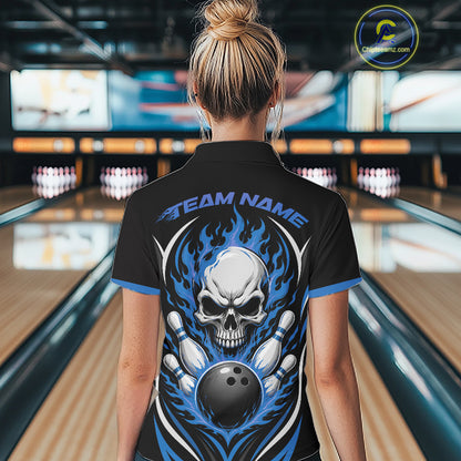 A woman viewed from behind wearing a black short-sleeve bowling shirt with a large back graphic featuring a white skull, blue flames, bowling pins, and a bowling ball, with the text 'TEAM NAME' across the upper back. 