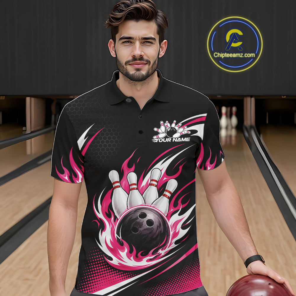 A man wearing a black bowling-themed short-sleeve polo shirt with pink flame bowling pin and ball graphics, standing in a bowling alley.