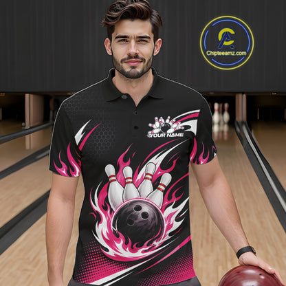 A man wearing a black bowling-themed short-sleeve polo shirt with pink flame bowling pin and ball graphics, standing in a bowling alley.
