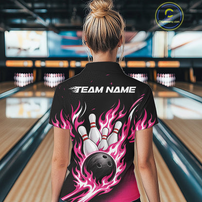 A woman viewed from behind wearing a black short-sleeve bowling-themed shirt with pink flaming bowling ball and pin graphics