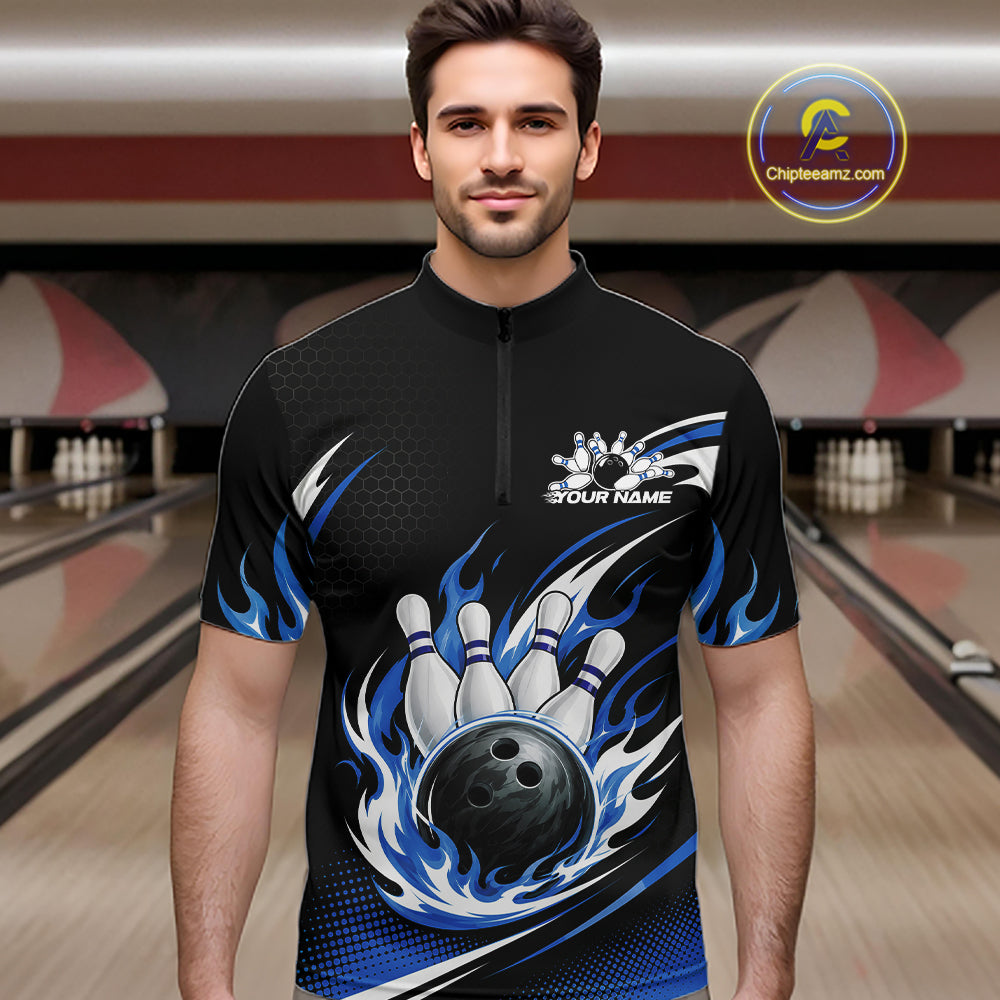 A man wearing a black short-sleeve bowling quarter zip shirt with a blue and white flame graphic, bowling pins, and a bowling ball design on the front. 