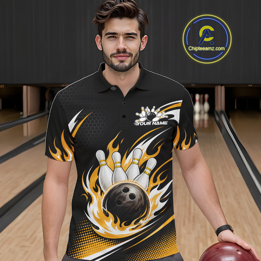 A man wearing a black and yellow bowling-themed short-sleeve polo shirt with a flame and bowling pin graphic, standing in a bowling alley. 