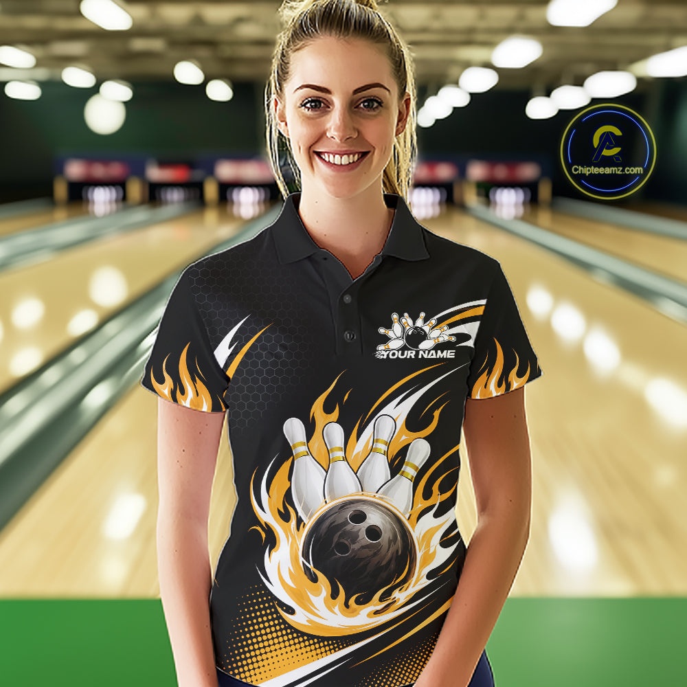 A woman wearing a black short-sleeve bowling-themed polo shirt with a large graphic of a bowling ball, pins, and yellow flames