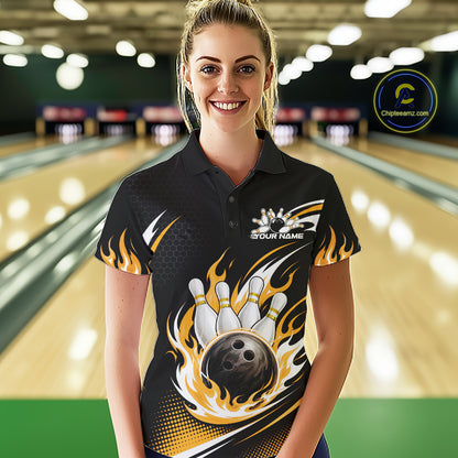 A woman wearing a black short-sleeve bowling-themed polo shirt with a large graphic of a bowling ball, pins, and yellow flames