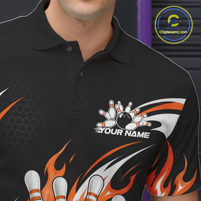 A close-up of a black short-sleeve polo shirt with a custom bowling-themed graphic. The design features orange flaming bowling ball and pin graphics