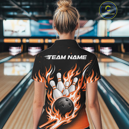 A woman viewed from behind wearing a black bowling-themed short-sleeve shirt with a large graphic of a bowling ball and white pins surrounded by orange and yellow flames, with 'TEAM NAME' printed across the upper back. 