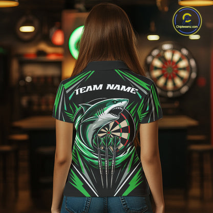 A woman viewed from behind wearing a short-sleeve black polo shirt with a green and white shark graphic, a dartboard design