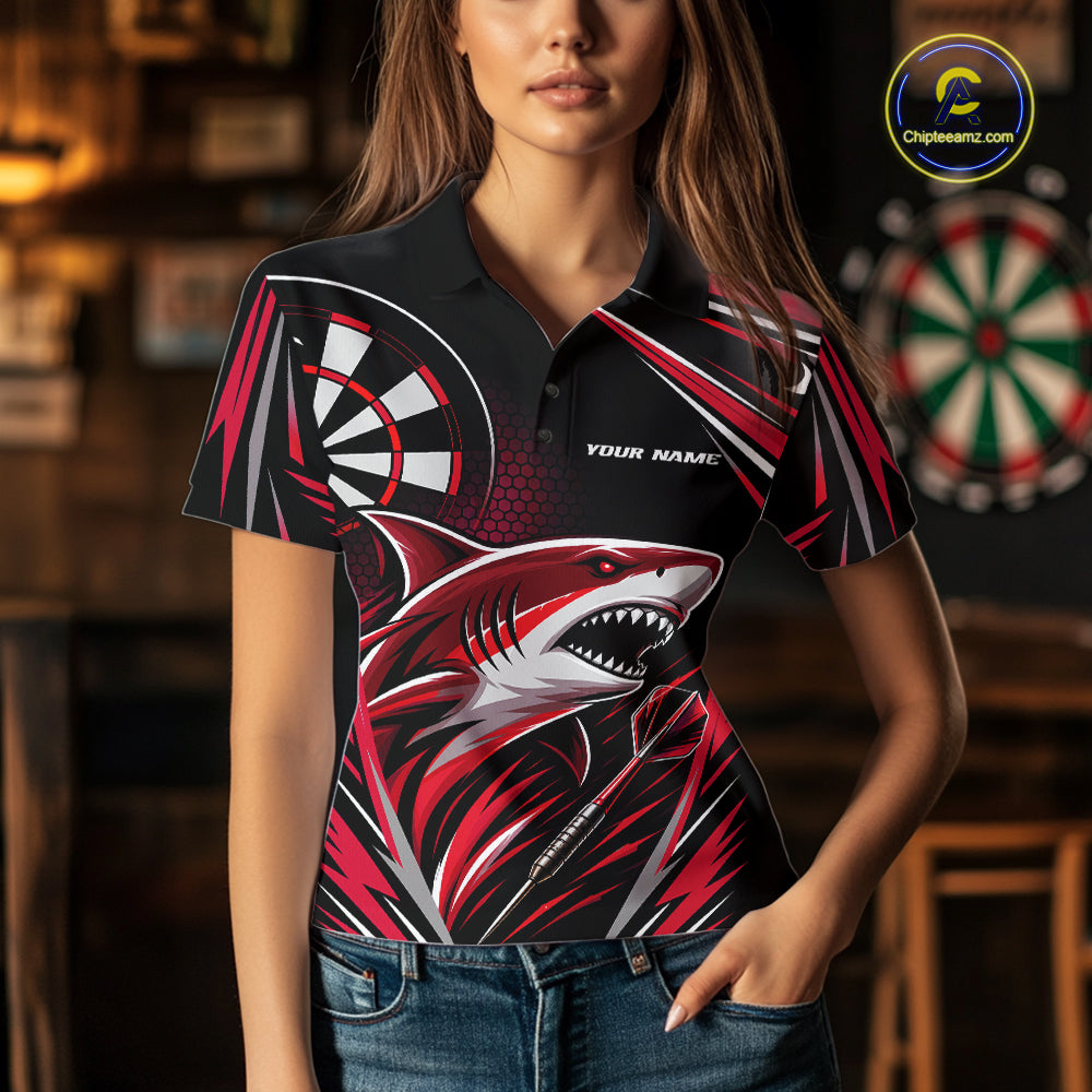 A woman wearing a short-sleeve polo shirt with a bold shark graphic and dartboard design on a black background