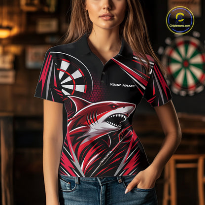 A woman wearing a short-sleeve polo shirt with a bold shark graphic and dartboard design on a black background