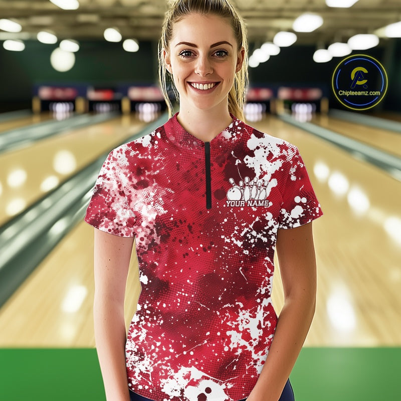 Woman wearing a pink and white bowling shirt with a personalized name on a bowling alley.