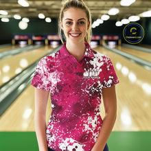 Load image into Gallery viewer, Woman wearing a pink and white patterned bowling shirt with a logo and text in a bowling alley.