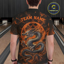 Load image into Gallery viewer, Back view of a male model in a bowling alley wearing an orange custom bowling polo shirt featuring an ancient dragon, flames, and a moon-inspired bowling ball design.