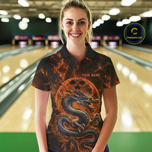 Load image into Gallery viewer, Front view of a female model in a bowling alley wearing an orange custom bowling polo shirt featuring an ancient dragon, flames, and a moon-inspired bowling ball design.