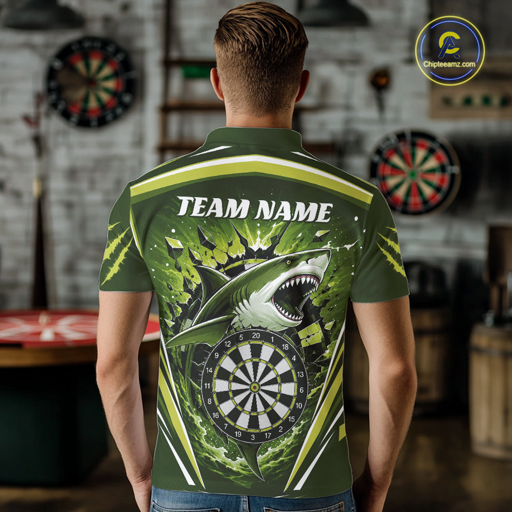 A man viewed from behind wearing a green short-sleeve polo shirt with a large shark and dartboard graphic on the back, plus the text 'TEAM NAME'. 