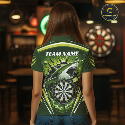A woman viewed from behind wearing a dark green short-sleeve polo shirt with a large shark and dartboard graphic on the back