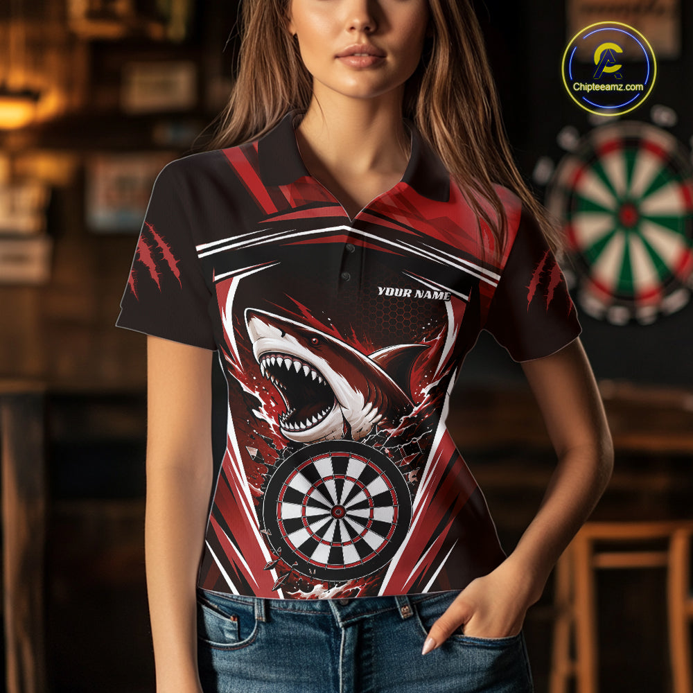 A woman wearing a short-sleeve polo shirt with a bold shark and dartboard graphic on the front